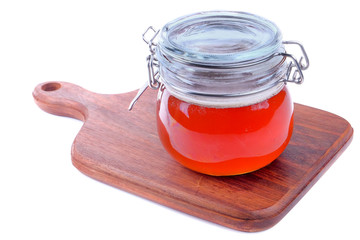 Fresh honey in jar isolated on white background