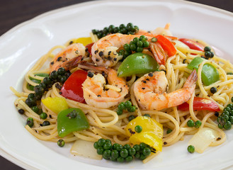 Spaghetti Prawns Stir Black pepper sauce Delicious Thai food in white dish on dark background