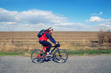 girl rides a bike on the road