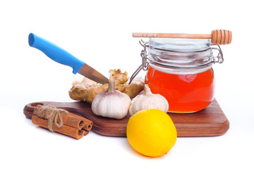 Alternative Medicine with Garlic, lemon, honey and Cinnamon  isolated on white background