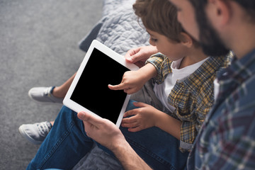 father and son with tablet