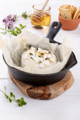 Baked camembert cheese with thyme and pepper