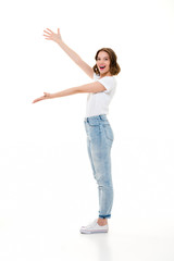 Cheerful pretty caucasian lady standing isolated showing copyspace.