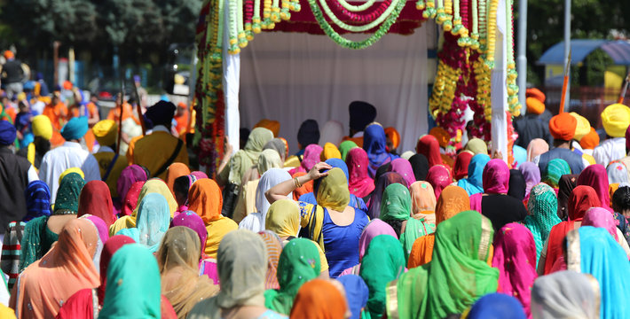 people with colorful clothes and women with veil in the head dur