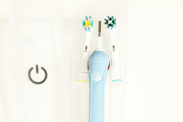 Electric toothbrush isolated on white with travel case background close up photo