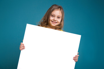 Pretty, little girl in tee shirt with brown hair hold clean paper