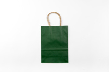 Dark green paper bag with handles on a white background top view