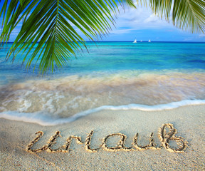 Vacation concept written on sand.
