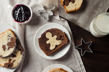  Rustic image with homemade sponge cake, with poppy seed and a glass of milk, on a vintage wooden table, in the morning light