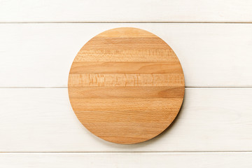 Empty wooden cutting board on a white background, top view