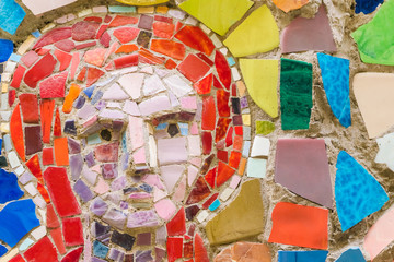Detail of beautiful old abstract ceramic mosaic with the image of the woman's face
