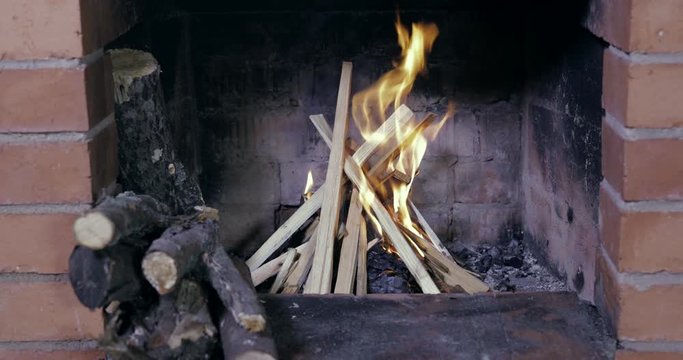 Kindling of a fireplace, firewood at the left