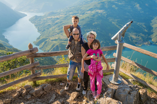 happy family on the viewpoint of the Banjska stena on the mountain Tara