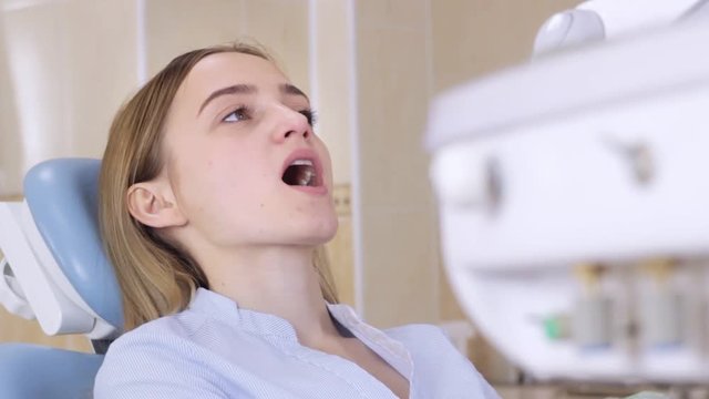 Dentist's office, Girl in dentist's chair with open mouth