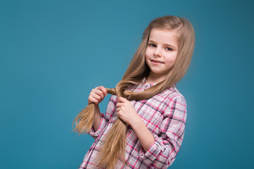 Little beauty girl in shirt with long brown hair