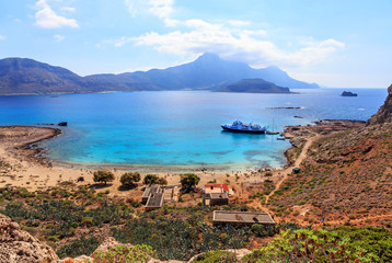 View from the island of Gramvous to the lagoon of Balos and the bay with a pleasure craft for tourists.