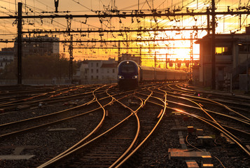 Obraz na płótnie Canvas A train on the railroad tracks during sunrise. Gare de Lyon-Perrache, Lyon, France.