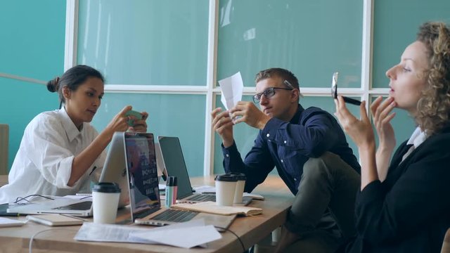 Funny Scene with Lazy Office Workers: Programmer Making Paper Plane, Designer Playing with Mobile Phone, Boss Making MakeUp Cosmetics. 4K.