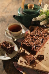 abstract topping chocolate brownies sliced cake with black tea 