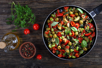 tasty Caponata with vegetables on skillet