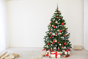 Christmas tree with red gifts in the white room Christmas
