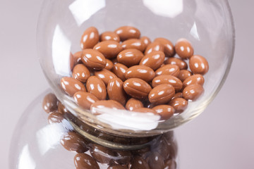 brown capsule medical flask on the mirror background