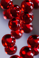red capsules on mirror background