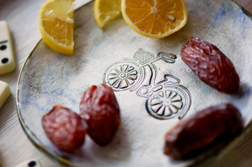 Fun atmosphere of a cozy evening eating dates, oranges, dominoes and dreams about travel