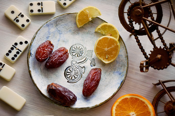 Fun atmosphere of a cozy evening eating dates, oranges, dominoes and dreams about travel