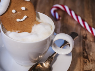 gingerbread man bathing in a cup of coffee