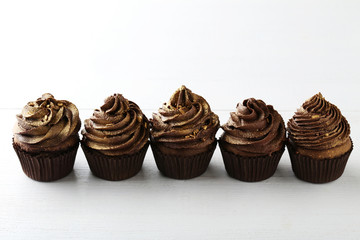Chocolate cupcakes on white wooden table