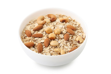 Oat flakes in bowl with nuts isolated on white background