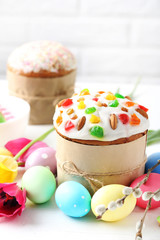 Easter eggs with cake on a white wooden table