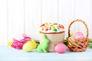 Easter eggs with cake on a blue wooden table
