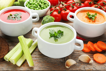 Vegetable cream soup with parsley on grey wooden table