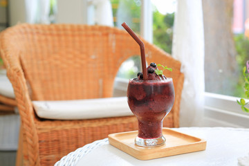 Glass of fresh blueberry smoothie at the cafe.