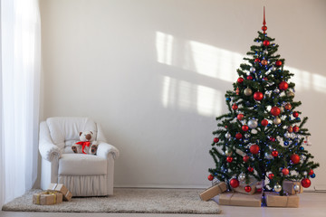 Christmas tree in a white room for Christmas with gifts