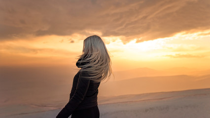 blonde girl in a bright yellow sunset