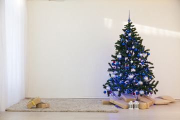 Christmas tree on Christmas day in a white room with gifts