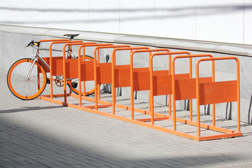 Orange bicycle stands on the orange bicycle park