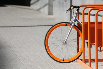 Gordijnen Orange bicycle stands on the orange bicycle park © Julie N