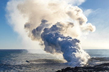 Fototapeta na wymiar Eruption of a volcano on the Hawaiian island on the ocean. Volcanic activity. Tourism. Field of frozen black lava