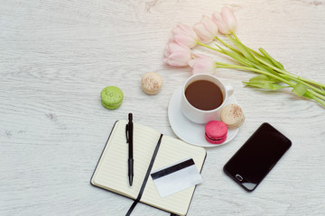 Planning of affairs. Coffee mug with dessert, notebook, pen, credit card and phone.