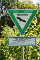 Text in German: Natural Monument. In this sanctuary is prohibited: leaving the path, plucking and...