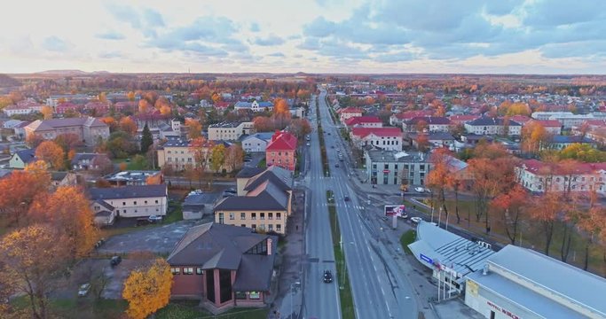 Aerial footage of traffic, cars and buses on the bridge, Jõhvi, Estonia.  Beautiful sunset with amazing pink clouds over the city.