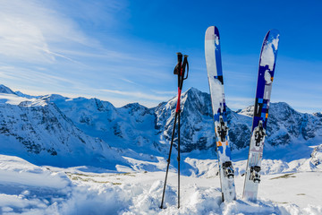 Ski in winter season, mountains and ski touring backcountry equipments on the top of snowy mountains in sunny day. South Tirol, Solda in Italy. - obrazy, fototapety, plakaty