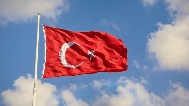Turkish Flag waving in the wind over blue sky with white clouds. Slow Motion, Loop, HD 1080p video. The flag of Turkey; A red flag featuring a white star and crescent often called as moon-star (Ayyild