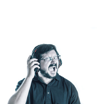 Portrait of 30 years old caucasian man Scream loud singing song and listen music with fade out blue color effect