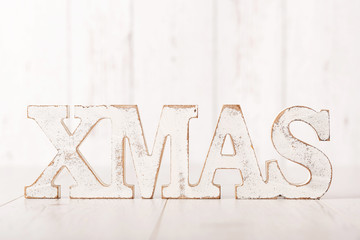 XMAS text on a wooden background