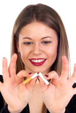 Attractive young woman breaking a cigar